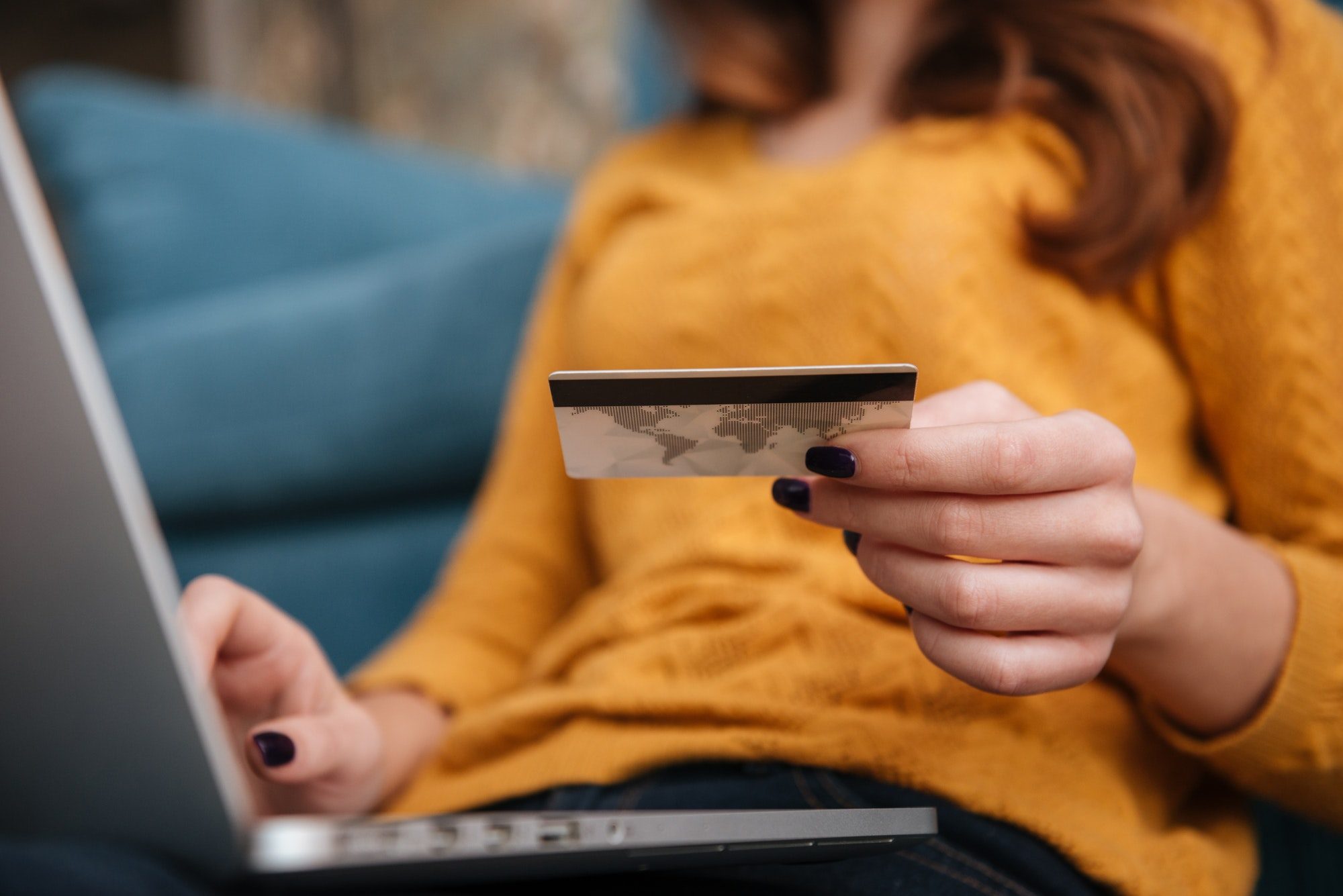 Close up of a woman buying online with bank card